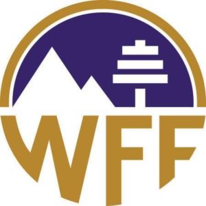 WFF logo featuring gold letters and an illustration of a mountain in a purple and gold circle